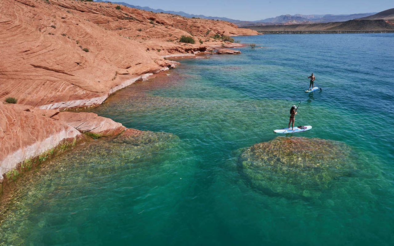 Paddleboarding on the clear water at Sand Hollow Reservoir near St. George Utah
